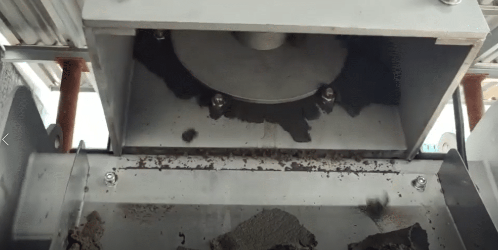 Sludge solids discharge from screw presses